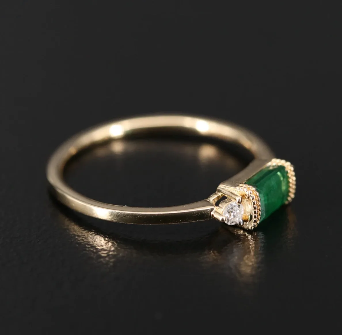 BAGUETTE EMERALD AND DIAMOND RING